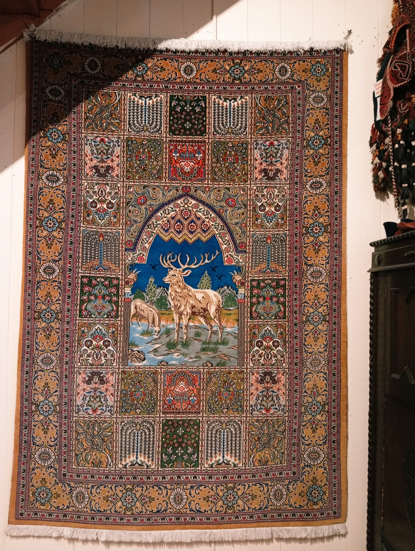 Qum pictorial Persian rug with garden panels surrounding a woven stag scene