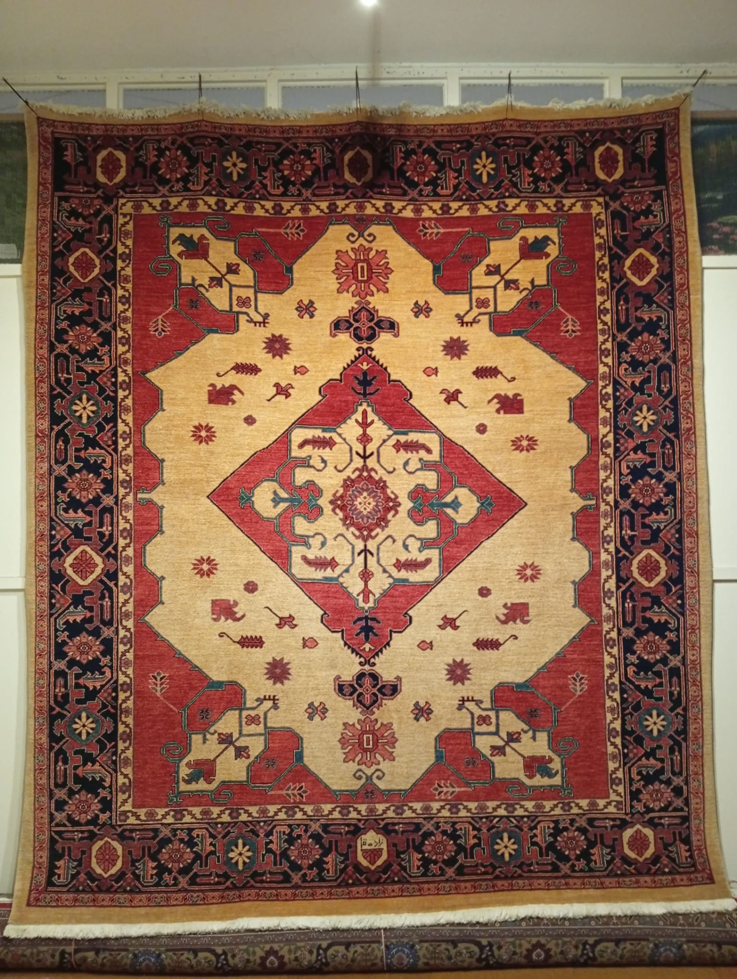 Hand-knotted Serapi Persian rug with gold field and red central medallion