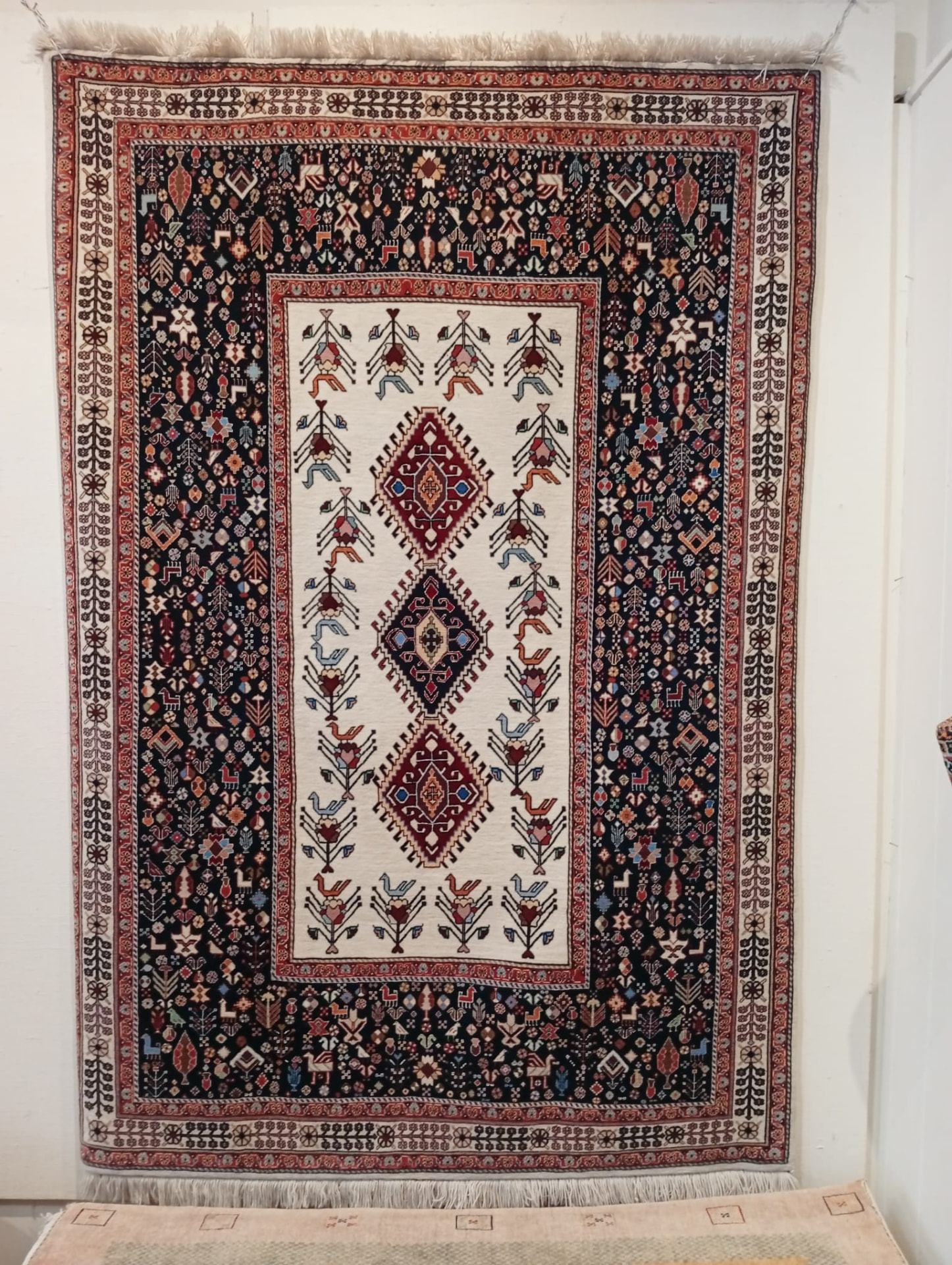 Hand-knotted Qashqai tribal Persian rug with indigo ground and ivory medallion panel